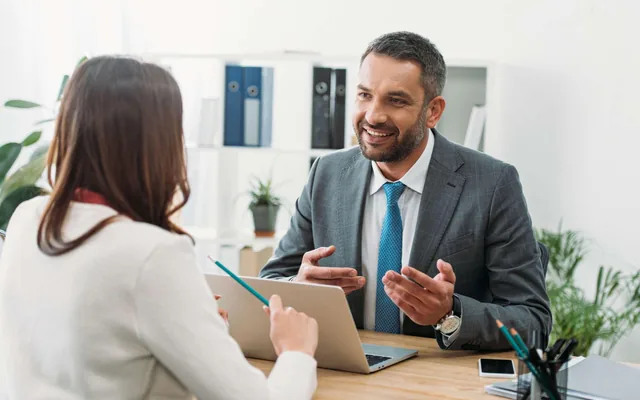 Consultant discussing business strategy with a client across a desk