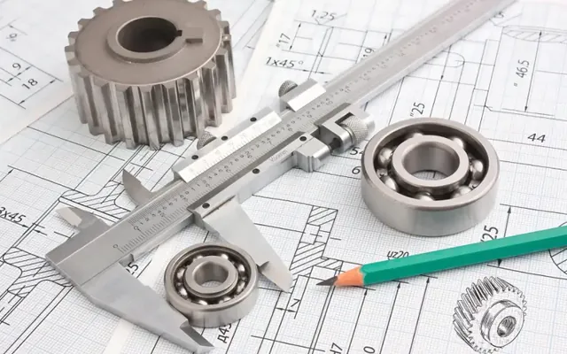 Vernier calipers, gear and bearings over technical drawings